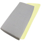 Grey chevron-patterned and yellow cotton jersey crib fitted sheets on a white background