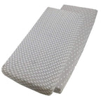 Grey star-patterned and grey cotton jersey crib fitted sheets on a white background